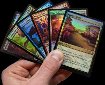 Hand holding 6 Magic cards